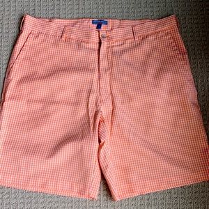 Peter Millar wicking golf short. Orange and white